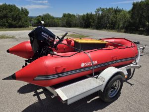 A red boat on a trailer.